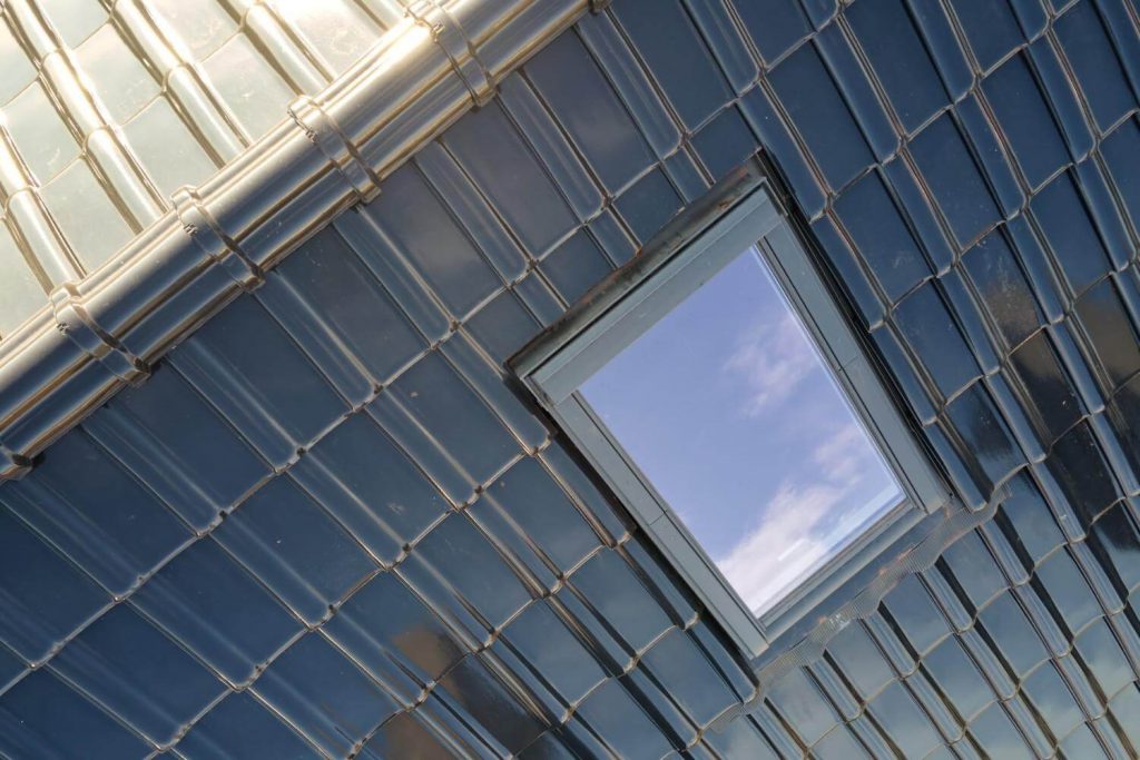 attic-window-on-glossy-ceramic-roof-tiles